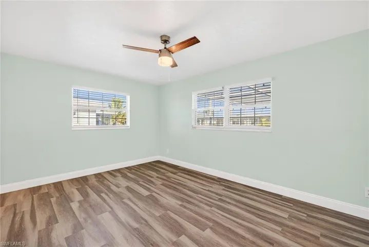 Unfurnished room with wood finished floors and ceiling fan