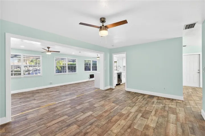 Unfurnished living room featuring light wood-type flooring and a ceiling fan