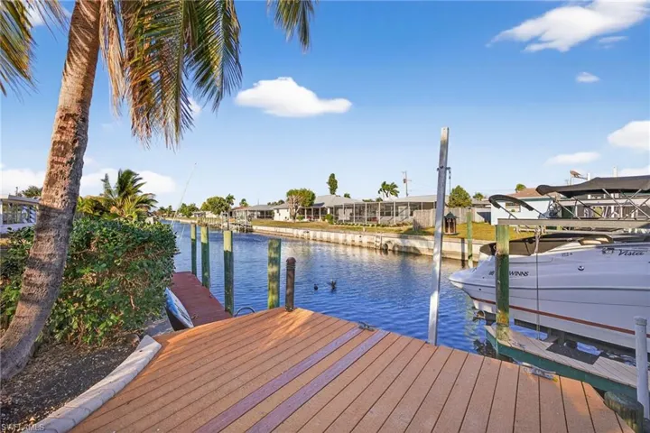 Dock area with a water view and a residential view