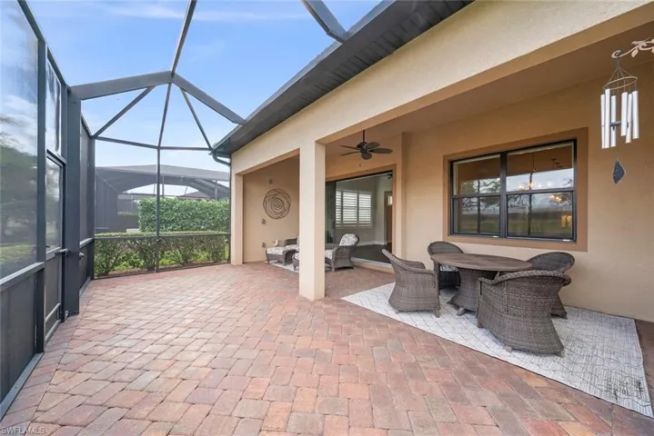 View of patio with a ceiling fan, outdoor dining area, and new screened  enclosure