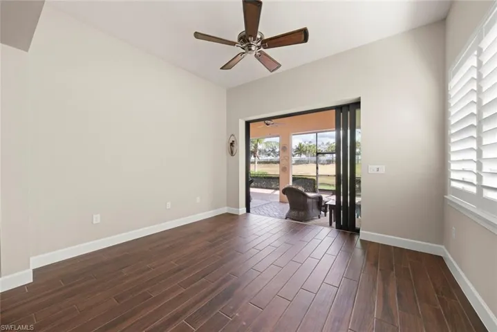 Sun room featuring  tile floors and a ceiling fan-hurricane slider doors & wood shutters