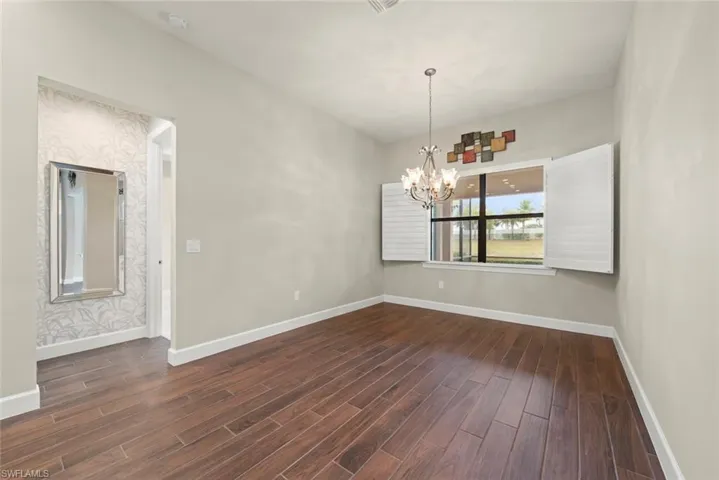 Dining area featuring dark Tile finished floors and hanging lights
