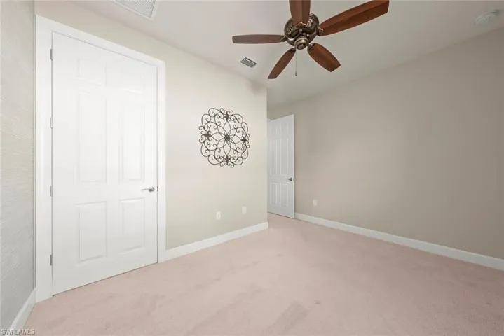 2nd bedroom with carpet and ceiling fan