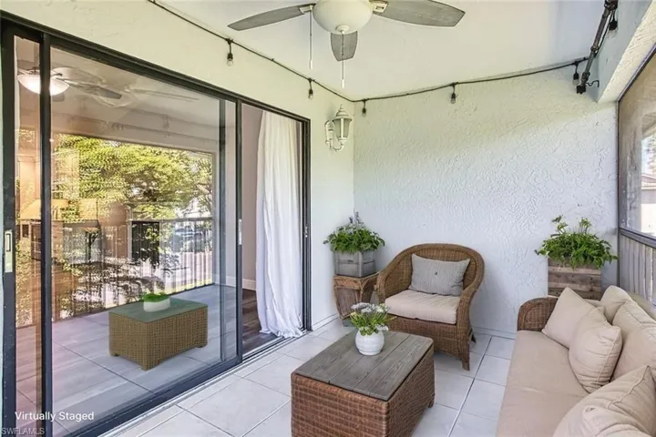 Sunroom / solarium featuring a ceiling fan and an outdoor hangout area *VIRTUALLY STAGED