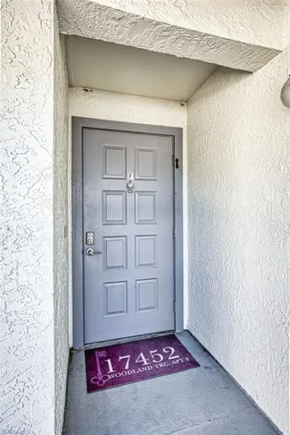 Property entrance featuring stucco siding