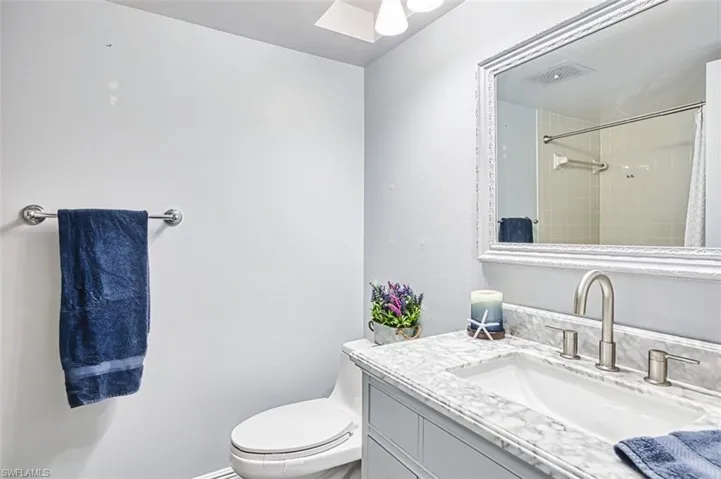 Bathroom with vanity and curtained shower
