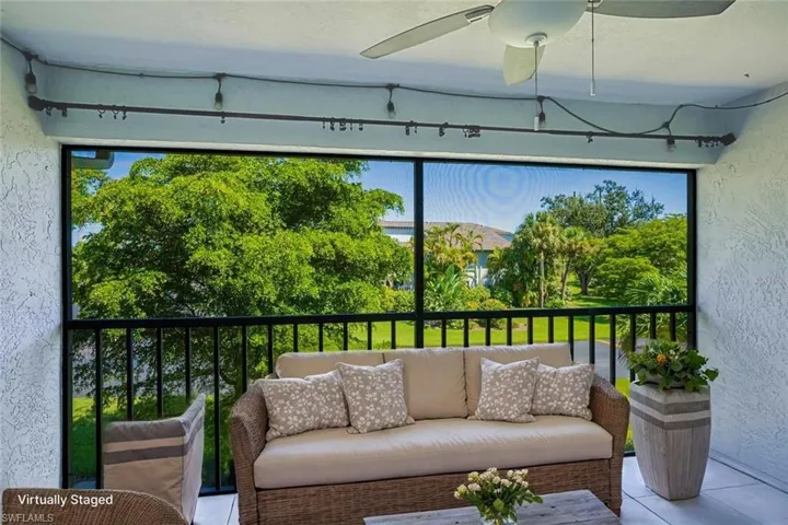Screened Balcony featuring a ceiling fan, and an outdoor hangout area *VIRTUALLY STAGED