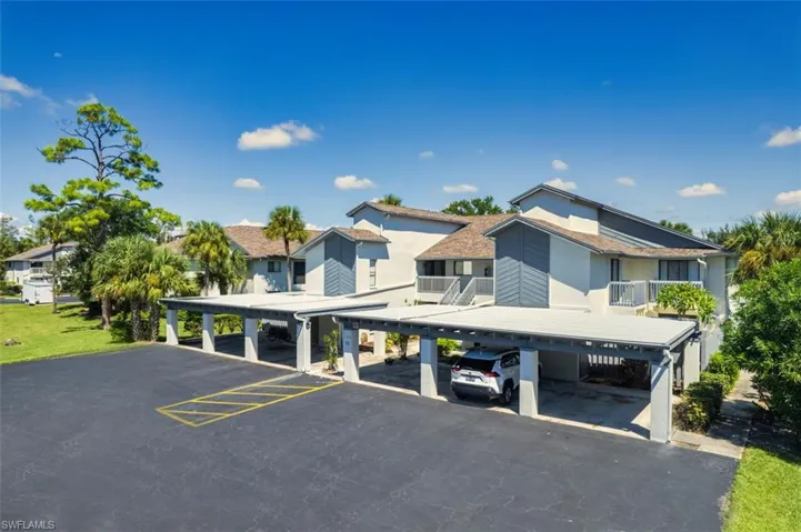 View of front of house with covered parking and a residential view