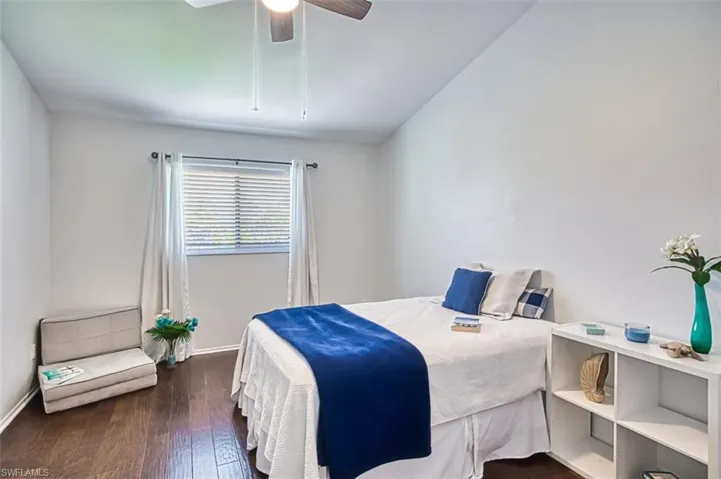 Bedroom featuring dark wood-style floors and ceiling fan
