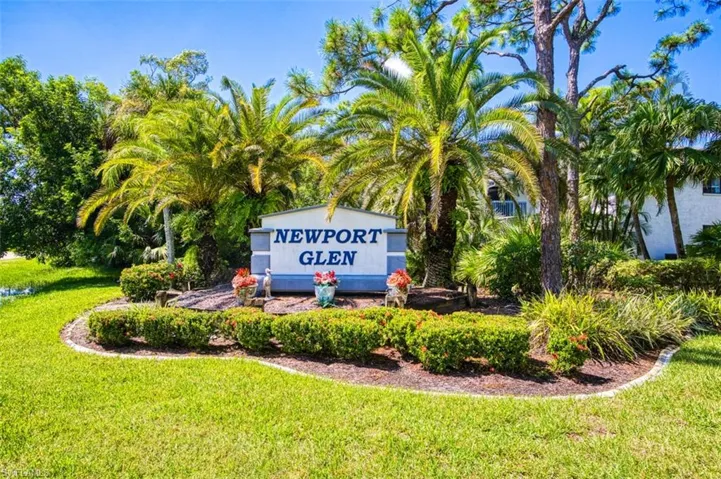 Community / neighborhood sign with a yard