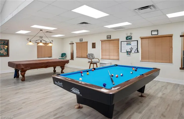 Playroom featuring billiards table, wood finished floors, baseboards, and a drop ceiling