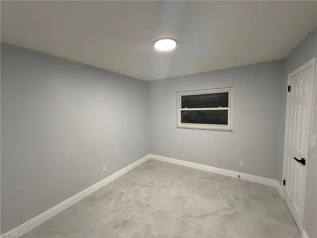Spare room featuring baseboards
