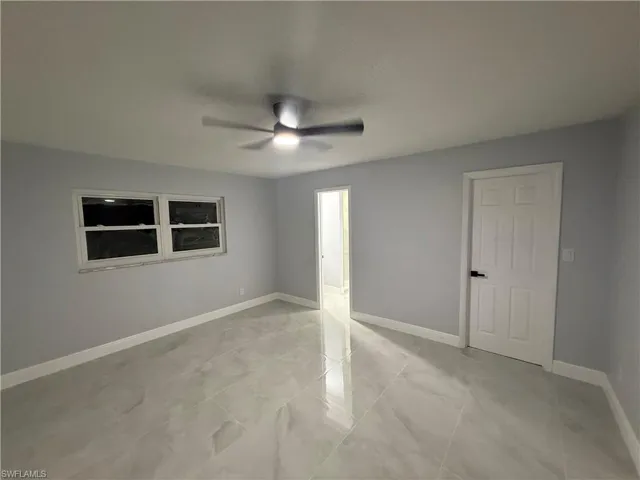 Unfurnished bedroom with ceiling fan and baseboards