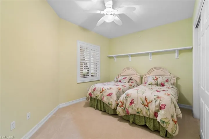 Bedroom featuring carpet, a ceiling fan, and a closet