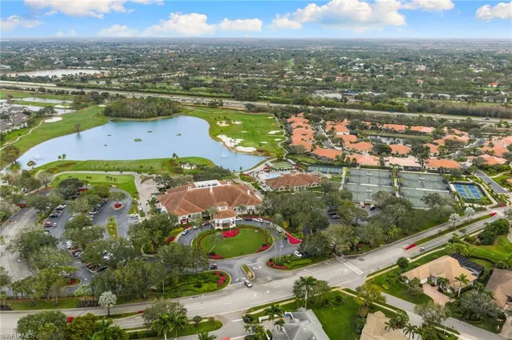Aerial view of property's location featuring a nearby body of water, a golf club, and nearby suburban area