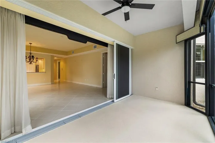 Unfurnished sunroom featuring a chandelier