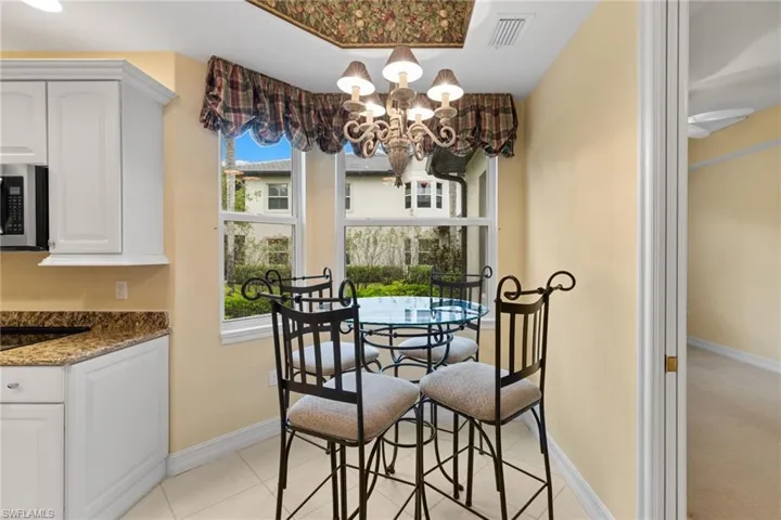Dining space featuring a chandelier and light tile patterned flooring