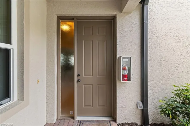 Doorway to property with stucco siding