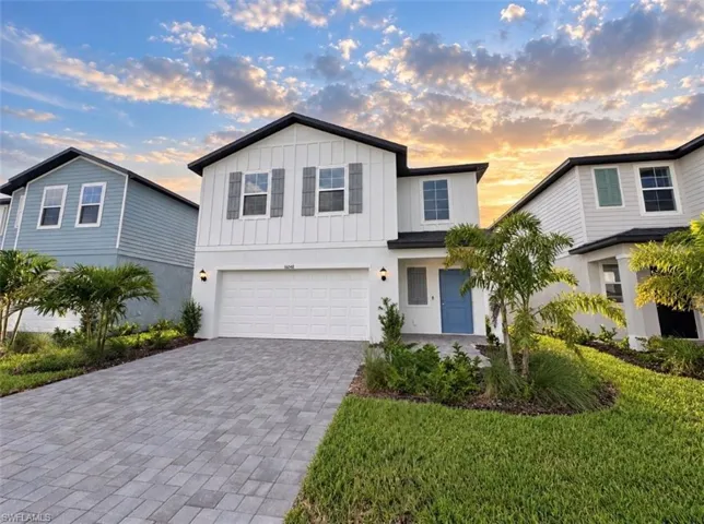 Modern exterior with white siding and dark trim
