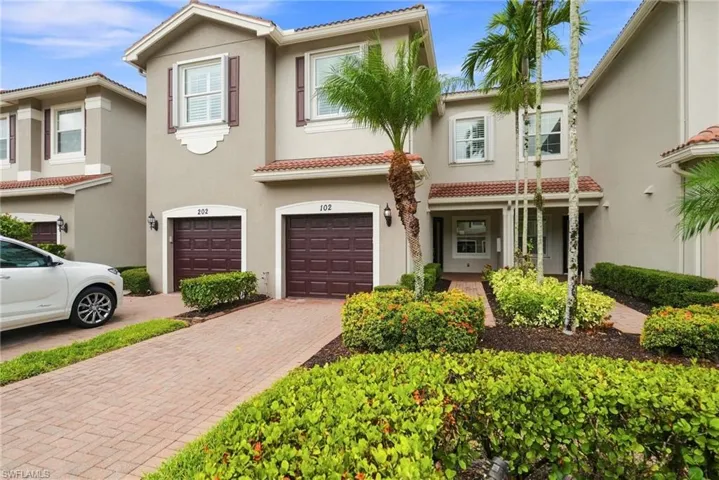 Driveway to the one car garage with walkway to entrance.