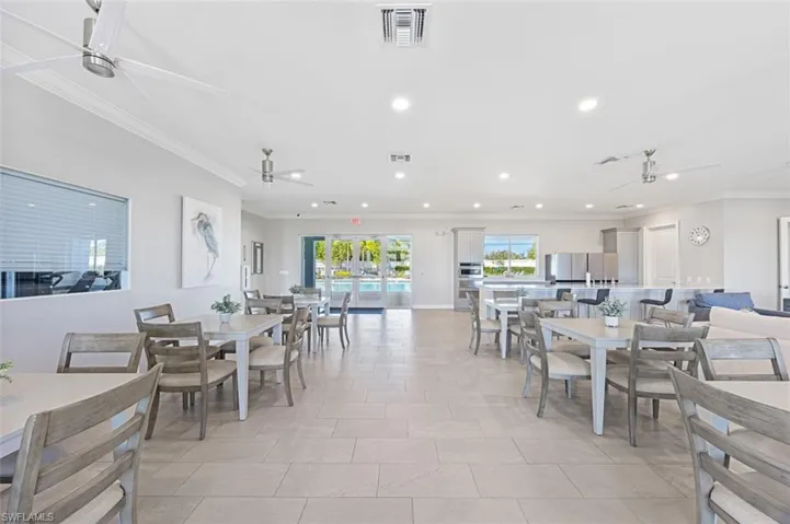 Dining space featuring ceiling fan, recessed lighting, crown molding, and light tile patterned floors