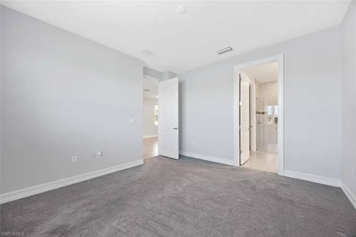 Unfurnished bedroom featuring carpet floors and baseboards