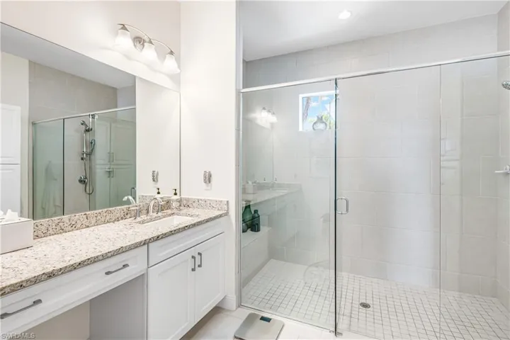 Bathroom featuring vanity and a shower stall
