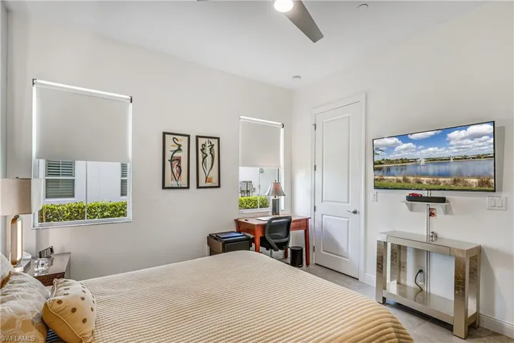 Bedroom featuring a ceiling fan and baseboards