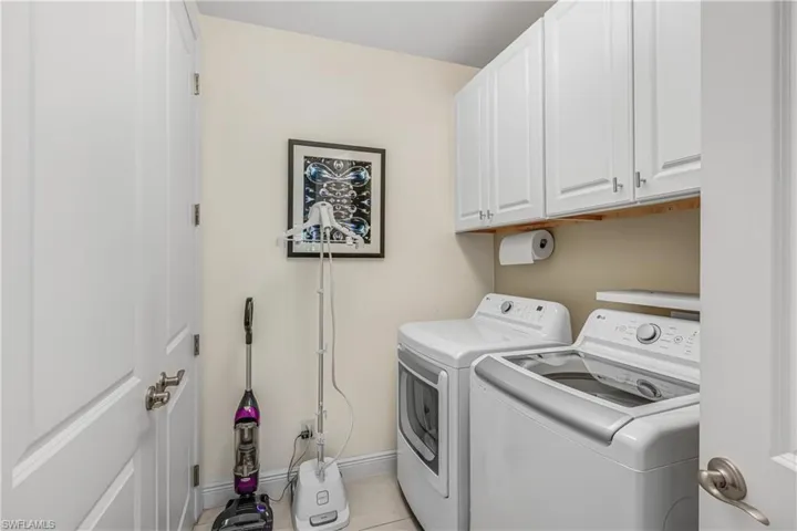 Laundry area featuring cabinet space and washing machine and dryer