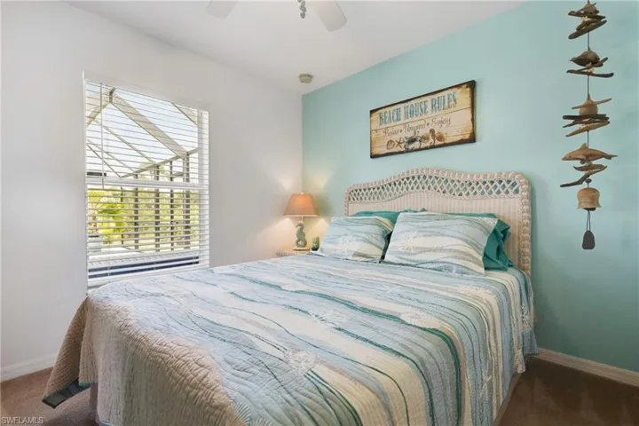 Carpeted bedroom featuring ceiling fan
