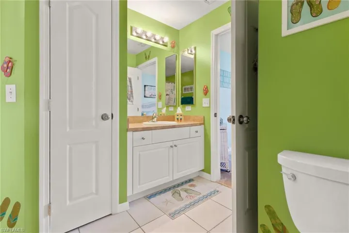 Bathroom with tile patterned floors, vanity, and toilet