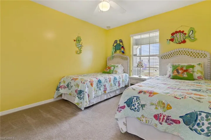 Carpeted bedroom with ceiling fan