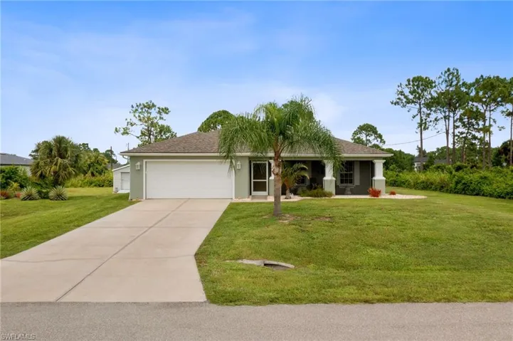 Ranch-style house with a garage and a front yard