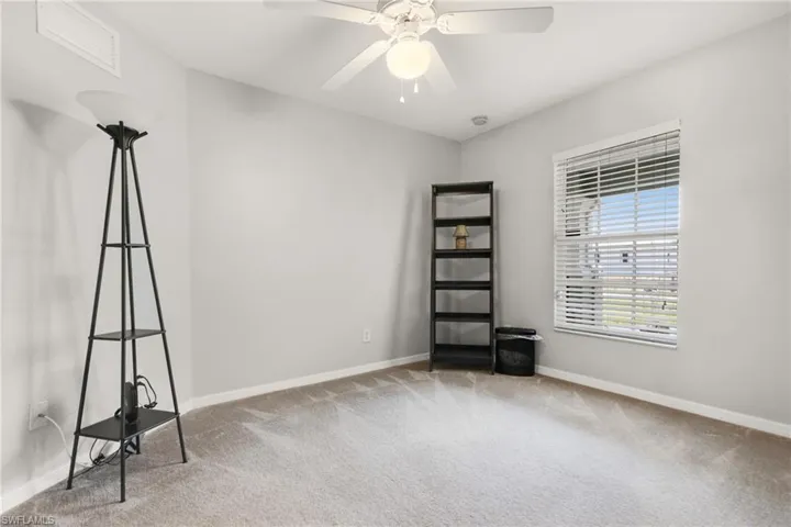Carpeted spare room with ceiling fan