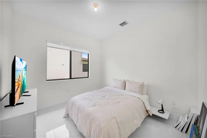 Room with smooth white walls and reflective white flooring