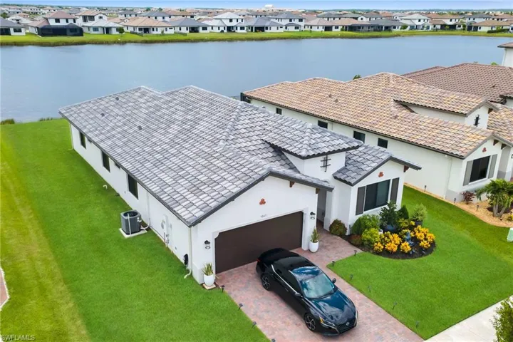 Contemporary residential property featuring a tiled roof and a two-car garage
