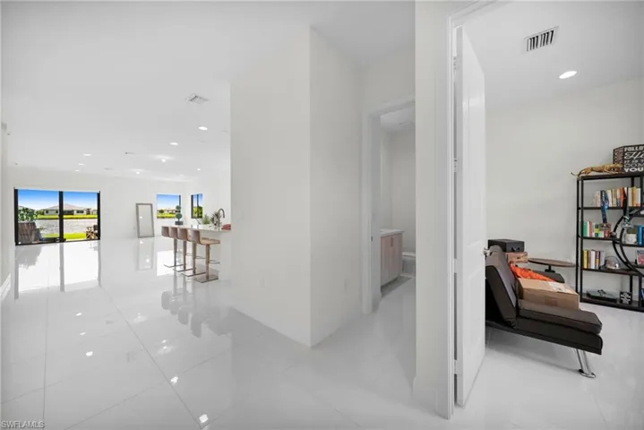 Open-concept living space with large format white tile flooring throughout