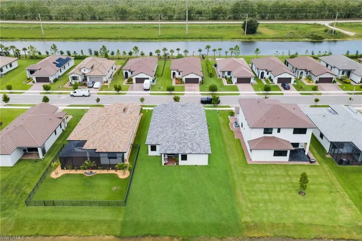 Residential community featuring single-family homes with diverse architectural styles, fenced backyards, and mature landscaping