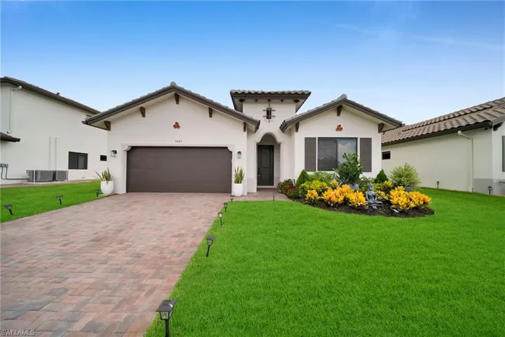 Stucco exterior with a tile roof and decorative corbels