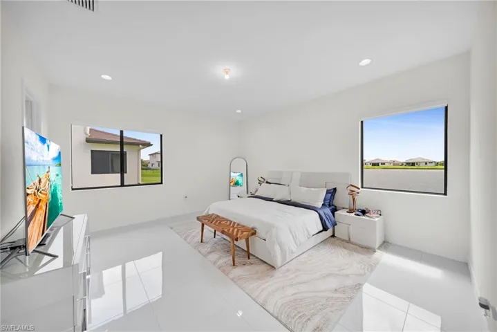 White-tiled flooring and recessed lighting illuminate this bright room