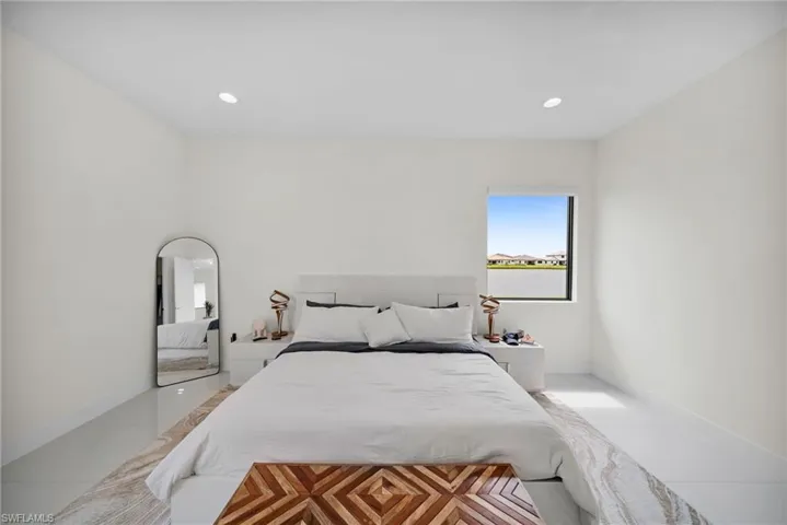 Bright room featuring light-colored flooring, recessed lighting, and a prominent window