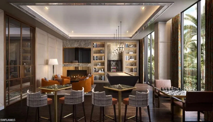 Sitting room featuring a tray ceiling and a premium fireplace