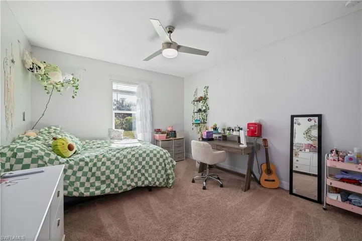 Carpeted bedroom with ceiling fan