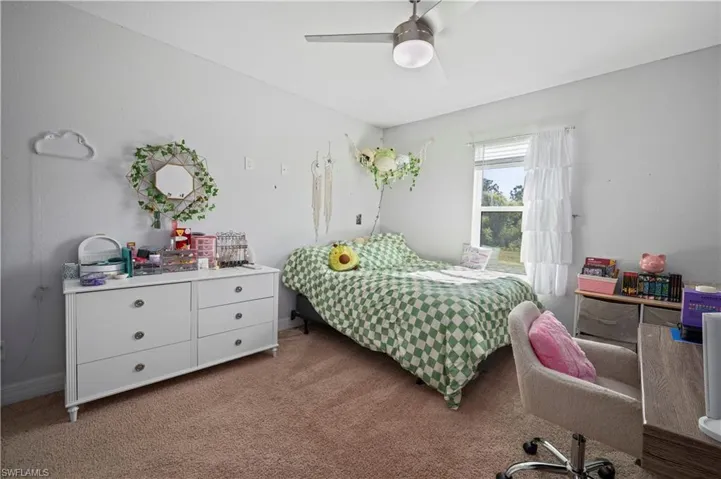 Bedroom with ceiling fan and carpet flooring