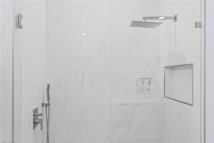 Bathroom view of a marble finish shower