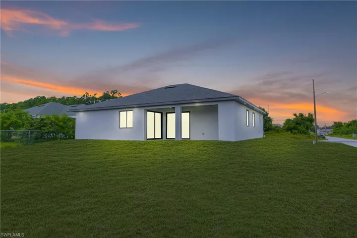 Back of property featuring stucco siding and a patio