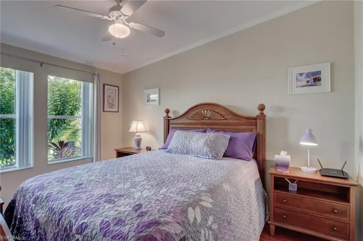 Bedroom with ceiling fan and crown molding