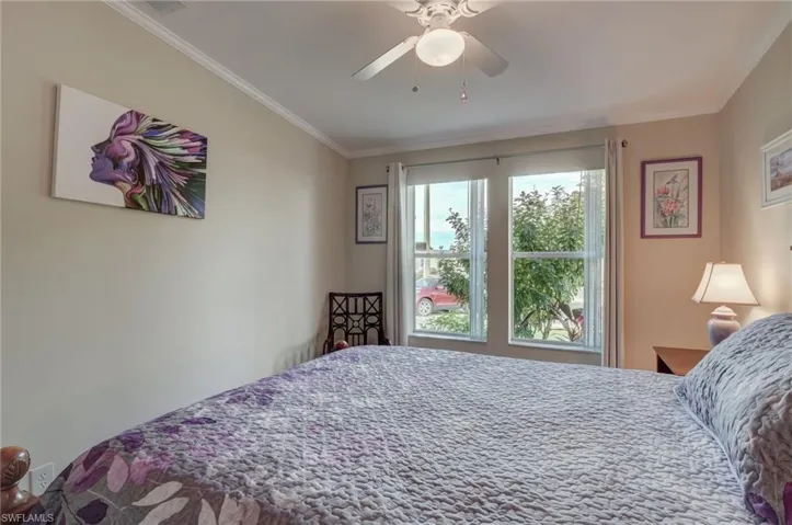 Bedroom featuring ceiling fan and ornamental molding