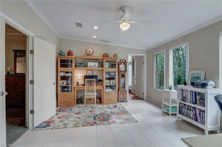Office Den featuring ceiling fan, light tile patterned floors, and crown molding