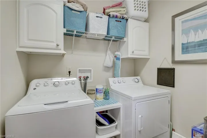 Laundry area featuring washer and dryer and cabinets